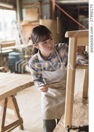 Furniture maker young woman 37998174