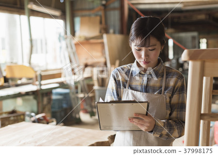 Furniture maker young woman 37998175