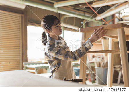 Furniture maker young woman 37998177