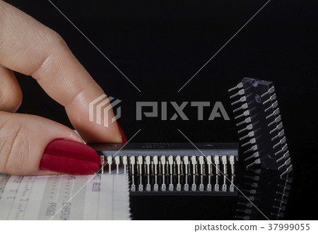 Two microchips holding it with the fingers Two microchips holding it with the fingers 37999055