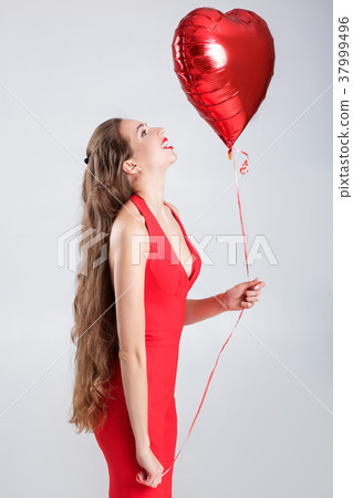 woman with heart shaped air balloons. 37999496