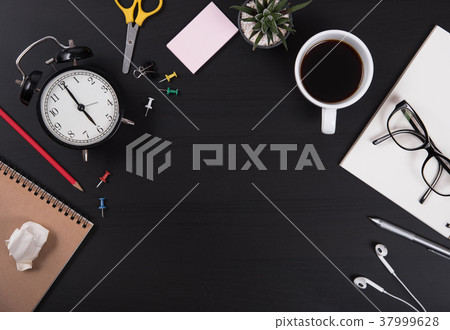 desk of office supplies and gadgets coffee cup 37999628