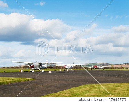 Small sport airplanes parked on runway Small sport airplanes parked on runway 37999775