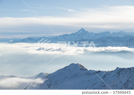 Snow mountains in backlight Snow mountains in backlight 37999845