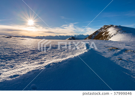 Snow mountains in backlight Snow mountains in backlight 37999846