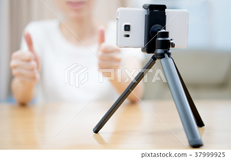 Young woman recording content for her blog 37999925