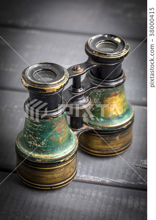Old binoculars covered with patina. Old binoculars covered with patina. 38000415