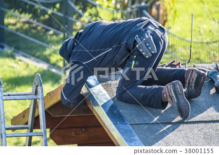 Roofer repairing the metal facing after storm Roofer repairing the metal facing after storm 38001155