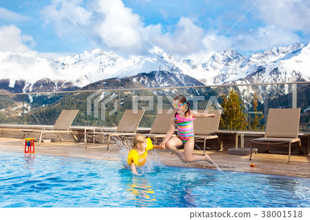 Kids in outdoor swimming pool of Alpine resort Kids in outdoor swimming pool of Alpine resort 38001518