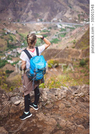 Woman tourist on cobbled path looking over 38001548