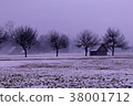 small barn next to the line of trees on rainy day	 38001712