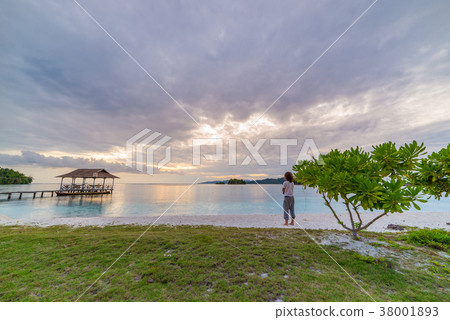 Tourist on tropical beach at sunset 38001893