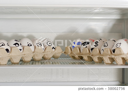 Two trays of eggs with smiles facing each other 38002736