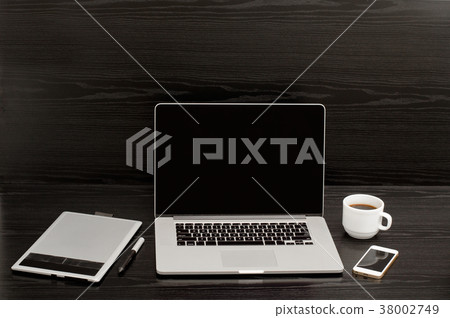 Open the laptop, mug of coffee, a telephone Open the laptop, mug of coffee, a telephone 38002749