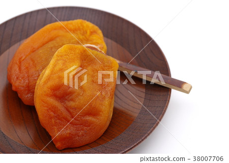Anpo rice cake Dried apricot cake served on a wooden confectionery plate White background k Close-up Lower left 38007706