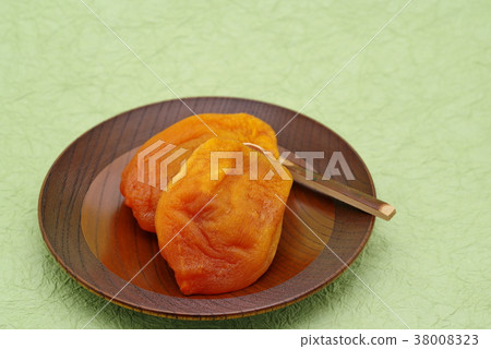 Anpo rice cake Dried apricot cake served on a wooden confectionery plate Green Japanese paper background c lower left 38008323