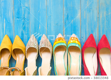 Collection of women's shoes on blue background Collection of women's shoes on blue background 38013348