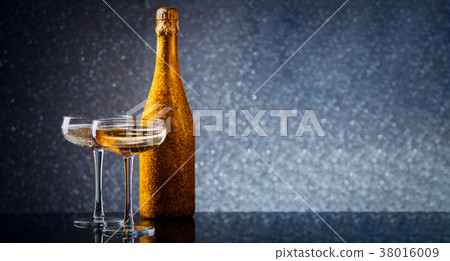 Photo of bottle of wine in gold wrapper with two 38016009