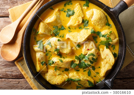 Spicy chicken in a sauce of coconut milk close-up Spicy chicken in a sauce of coconut milk close-up 38016610