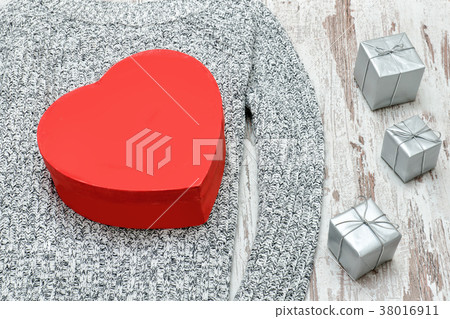 Red heart shaped box on a knitted sweater Red heart shaped box on a knitted sweater 38016911