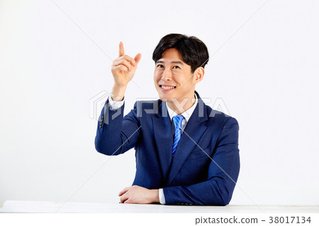 20s business man, young man, smiling, sitting at a table 20s business man, young man, smiling, sitting at a table 38017134