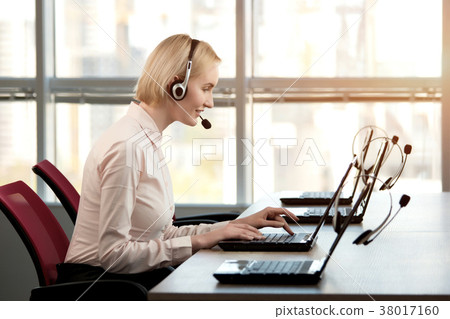 Adorable smiling female callcenter agent. Adorable smiling female callcenter agent. 38017160