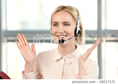 Female blond call center operator portrait. Female blond call center operator portrait. 38017172
