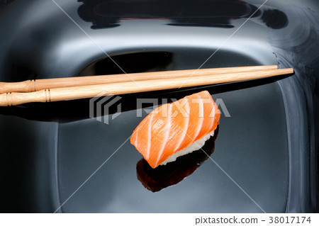 Sushi and chopsticks on black plate Sushi and chopsticks on black plate 38017174