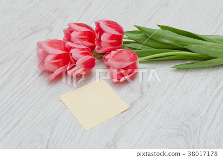 Clean card, pink tulips. Light wooden background Clean card, pink tulips. Light wooden background 38017178