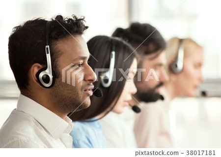 Black call center operator with colleagues. Black call center operator with colleagues. 38017181