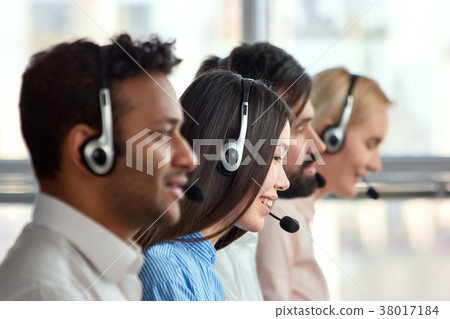 Asian girl with headset working in a company. Asian girl with headset working in a company. 38017184