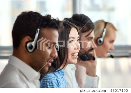 Four support phone operators at workplace. Four support phone operators at workplace. 38017190