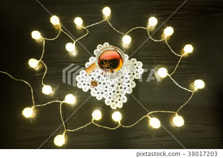 Mulled wine with spices on a lacy napkin Mulled wine with spices on a lacy napkin 38017203