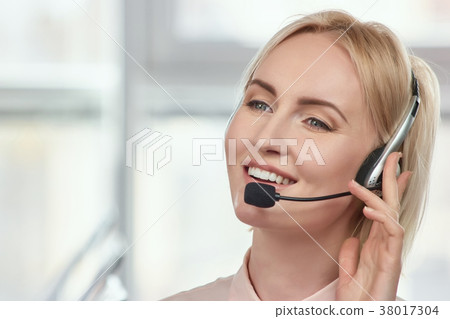 Mature operator with headset portrait. 38017304