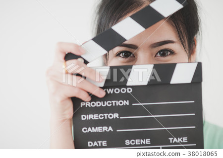 Young Asian woman playing clapperboard Young Asian woman playing clapperboard 38018065