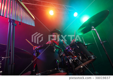 The drummer plays percussion. The drummer plays percussion. 38019837