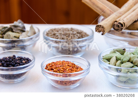 Variety of indian spices in glass bowls Variety of indian spices in glass bowls 38020208