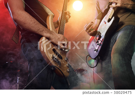 Guitarist and bass player perform on stage. Guitarist and bass player perform on stage. 38020475