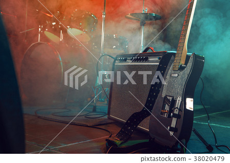 Guitar and combo on stage. 38020479