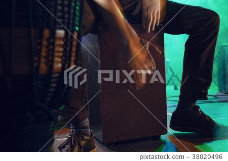 Musician plays the Cajon on stage. 38020496