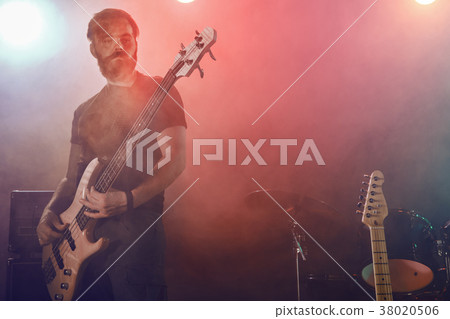 Bass player perform on stage. 38020506