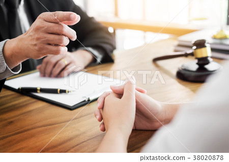 business people and lawyers discussing contract papers sitting a 38020878