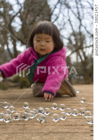 Girls playing with marbles 38021457
