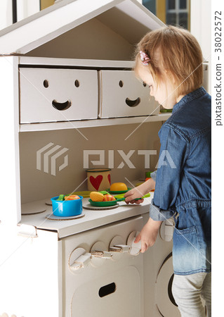 toddler girl playing with toy kitchen at home toddler girl playing with toy kitchen at home 38022572