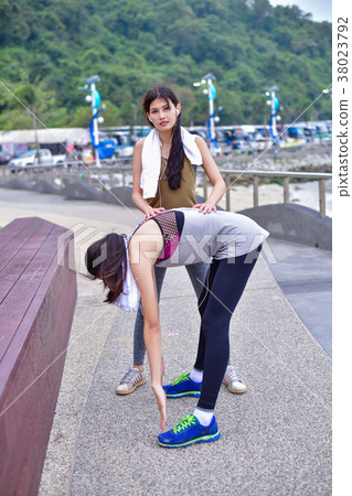 Sports concept. Beautiful girl is exercising on the beach with w 38023792
