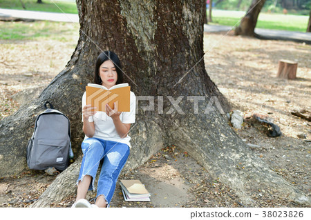 Education Concepts. Asian women reading books in the park. Beaut Education Concepts. Asian women reading books in the park. Beaut 38023826