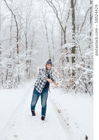 man in plaid shirt in the woods in winter 38024429