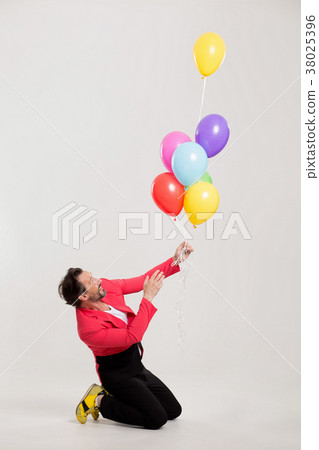 man in red jacket with colorful balloons 38025396