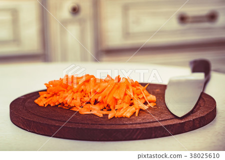 Cut carrot on wooden board and knife Cut carrot on wooden board and knife 38025610