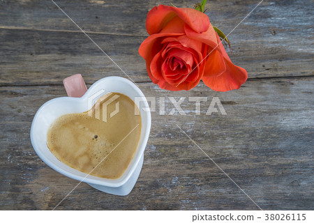 heart shape mug of coffee and scarlet rose  38026115